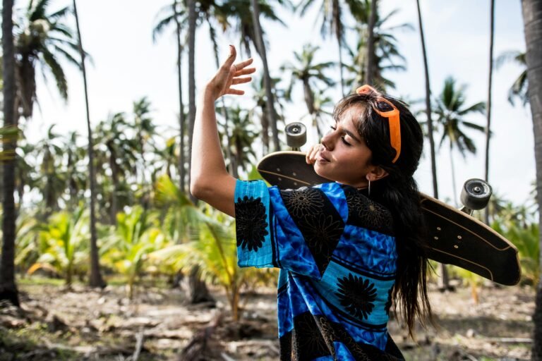 Young woman with longboard in tropical setting exuding freedom and carefree vibes.